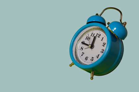 Full frame of alarm clocks on blue background Blue alarm clock. Blue alarm clock on a light blue background. Flying alarm clock.の写真素材