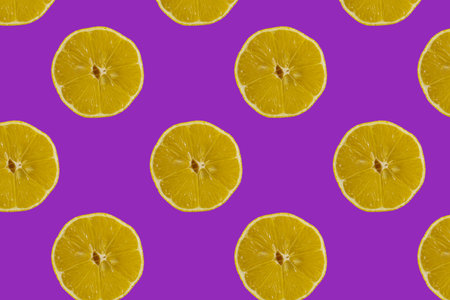 Fruit pattern. Colorful pattern of lemon slices on a purple background. Photo collage. Minimum...