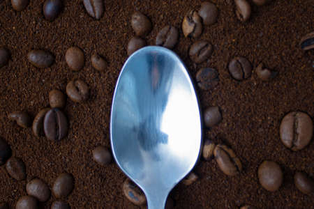 Background from coffee beans and spoons, top view. Bean coffee from top to bottom. Coffee beans background.の写真素材