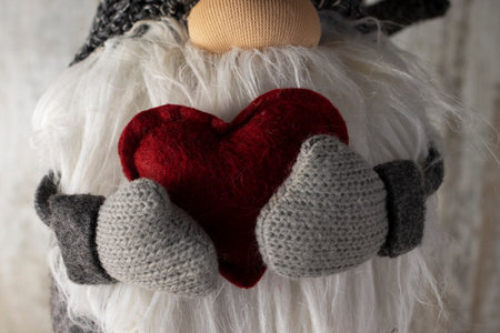 Hands in Knitted Mittens Hold a Beautiful Red Heart. Love, Valentine's concept. Happy Valentine's...