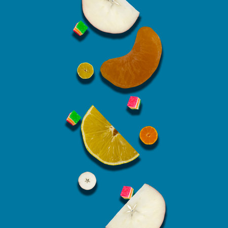 Sweet Pattern: Mandarin, Lemon and Apple Slice Flying Downward on a Blue Background. summer fruits. Concept of Summer and Fresh Fruits.の写真素材
