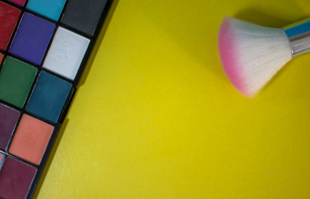 Composition with Makeup Brushes and Eyeshadows. Colorful Shadows, Creative Abstract Design Background Photo. Eyeshadow Palette Background.の写真素材