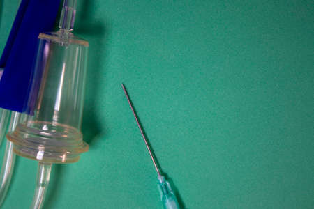 Medical Plastic Intravenous System. Close-up of the Dropper and Needle, Central Venous Conduit on a Blue Background. medical equipment. Health Concept.の写真素材