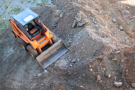 Excavator on the Site during earthworks. Tractor Works at the Construction Site. construction concept.の写真素材