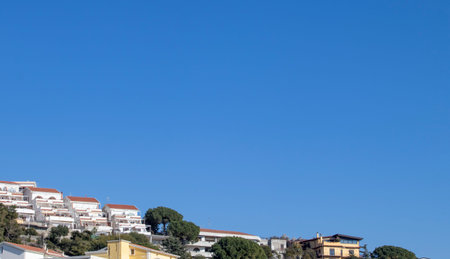 South of Italy, Calabria. Colorful Cabins on Scalea Beach with a Bright Blue Sky in the Background....