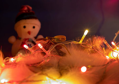 Christmas Decor Close-up with Glowing Pink, Yellow, Orange Lanterns on the Background of a Snowman....