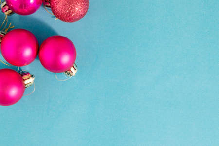 Pink Christmas Light Bulbs. Christmas Background from Pink Balls, Ornament on a Turquoise Background. Happy New Year and Merry Christmas.の写真素材