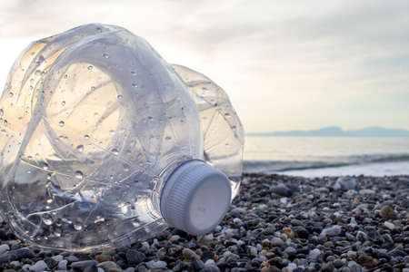 Plastic Water Bottle on the Beach. Volunteer concept. environmental pollution. ecological problem.の写真素材