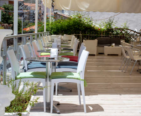 Cafe interior. open air cafe. Modern family restaurant with bright interior and furniture. Summer outdoor cafe, coffee shop or restaurant with table, chairs.の写真素材