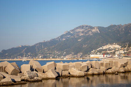 Beautiful view in Salerno in southern Italy at dawn. Pink and blue sky in the background. The Tyrrhenian Sea at sunset, in Salerno, Italy. Huge Stones are reflected in the clear blue water.の写真素材