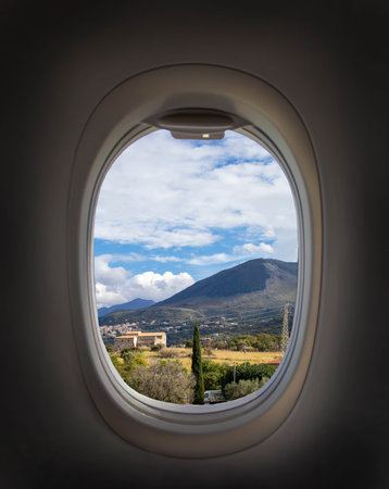Airplane Window with Beautiful Sky. Airplane Window. View of the Mountains and Clouds. Travel and Tourism Concept. New Scenic Spots.の写真素材