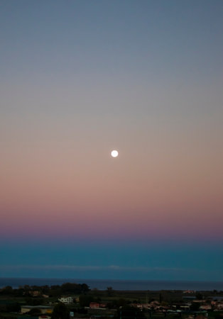 Beautiful Pink and Purple Full Moon Rise at Sunset. Early Morning Dawn Twilight with Moon.の写真素材