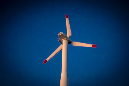 Modern White Wind Turbine Against the Blue Sky. Vignette, Energy Windmills, Ecological Power Concept...