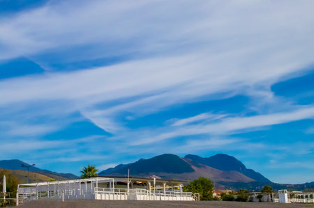 Amazing View of the Beach with a Restaurant Against the Background of the Azure Sky and Mountains, Calabria Coast, Italy.の写真素材