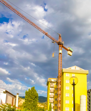 Crane and Construction Site Against the Blue Sky. Exterior Design of Modular Houses of Modern Architecture.の写真素材