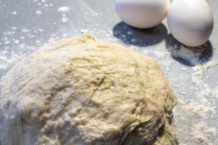Yeast Dough for Bread or Pizza, Buns, Pasta on a Floured Surface. Bread preparation. Mixing Dough.