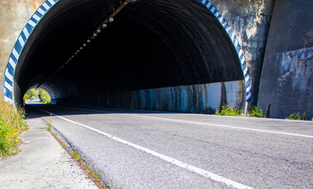 Light at the End of Tunnel. Road Tunnel Concept. Horizontal Landscape with Entrance to the Tunnel.の写真素材