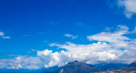 View of the Clouds Over the Mountain. High Angle View Blue Sky Over Mountain. View on Mountains. Mountain Sky and Land Landscape.の写真素材