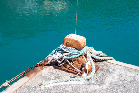 Old Mooring Bollard with rope Tied on Pier. Boat Tied With a Rope on a Mooring.