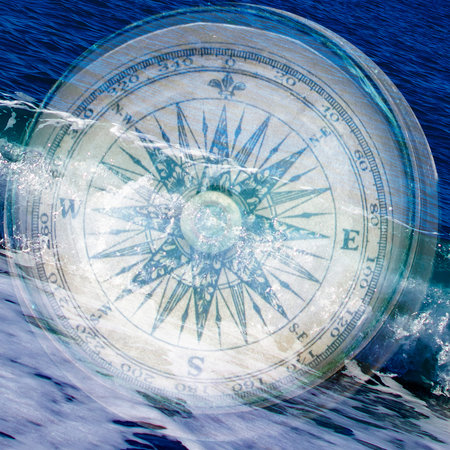 Compass on the Background of Ocean Waves. Close up of Antique Compass. Compass with Natural Blur Background. travel concept.の写真素材