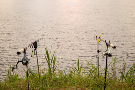 Fisherman's Fishing Rods, Catches Fish on a Foggy Sunrise. Fishing Concepts.の写真素材