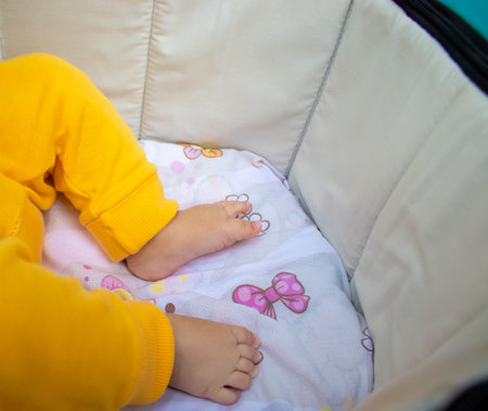 Baby Legs and Bottom in a Diaper and Yellow Panties, Top View, Copy Space.の写真素材