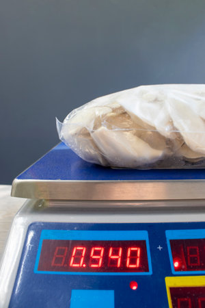 Dumplings in packaging on scales. Weighing products before sale.の写真素材