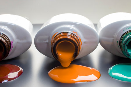 Nail polish of different colors spilled. Colorful nail polish bottles.の写真素材