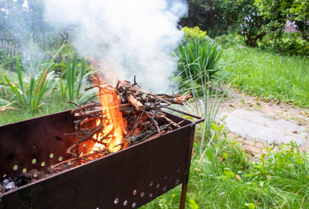 BBQ grill with fire outdoors. Tongues of flame. Time to get on the grill.の写真素材