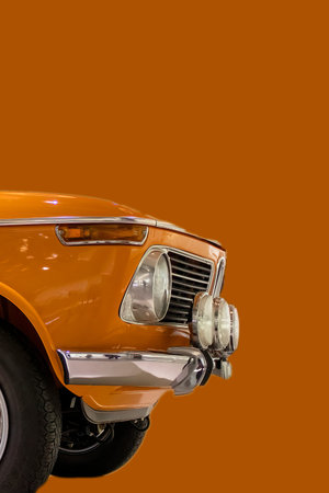Car close-up on an orange background. Automotive transport or automobile industry concepts. View...