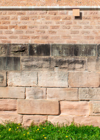 Grass by the ancient wall. Ready-made banner for advertising. Creative background.の写真素材