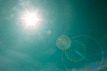 Blue sky. Bright midday sun illuminates the space.の写真素材