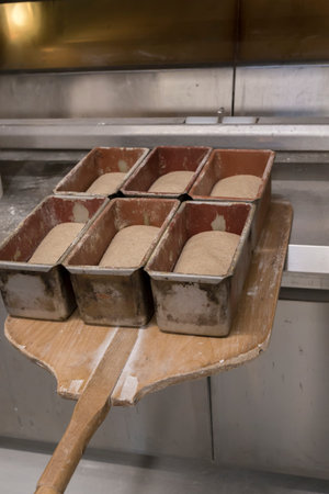 Entering bread loafs in the oven with the shovel