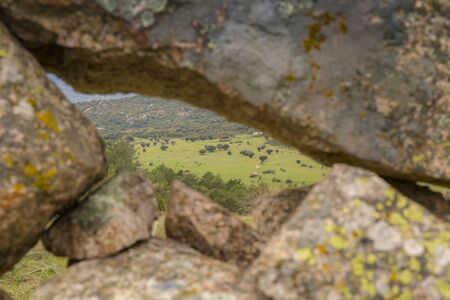Mountain landscape framed by a stone wallの写真素材