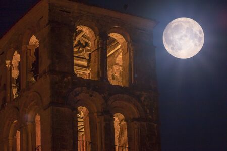 Church tower and full moonの写真素材
