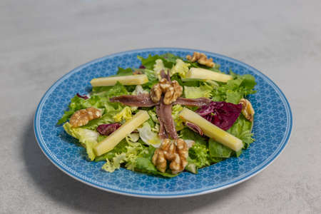 Healthy salad with cheese, nuts and anchoviesの写真素材