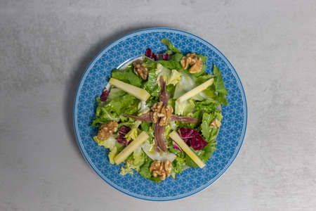 Healthy salad with cheese, nuts and anchoviesの写真素材