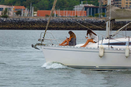 Two girls chilling in a boatの写真素材
