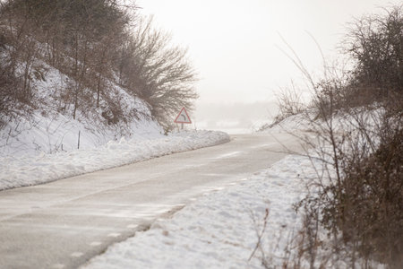 Lonely winter road, almost covered in snowの写真素材