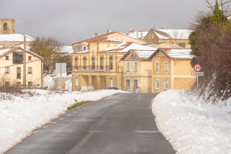 Lonely winter road that reaches to a small villageの写真素材