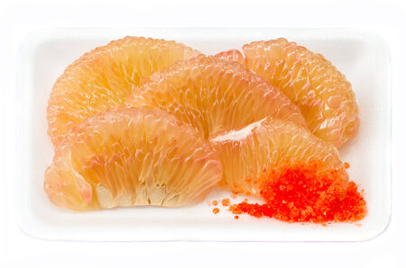 pieces of pomelo with salt & peppers on foamdishの写真素材