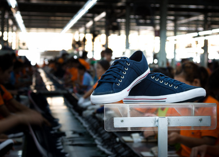 navy blue sneaker shoe in footwear industryの写真素材