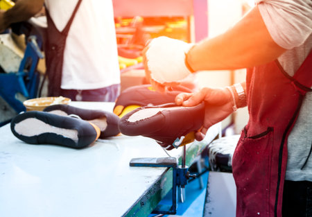 skill worker making shoe in footwear production lineの写真素材