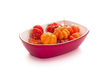 star gooseberry in magenta bowl on white backgroundの写真素材