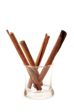 closeup Cinnamon stick spice in a glass isolated on white backgroundの写真素材