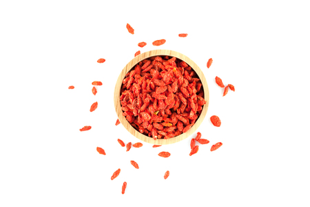 Goji berry in wooden bowl isolated on white backgroundの写真素材