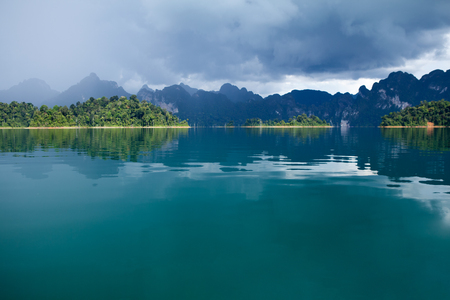 lake view of Ratchaprapa dam with rainstorm in Khaosok, Surathani, Thailandの写真素材