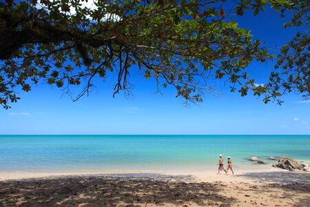 PHANG NGA, THAILAND - FEBRUARY 14: Tourist is walking along beach in the morning at Khaolak beach on the February 14, 2013 in Phang Nga, Thailandのeditorial素材