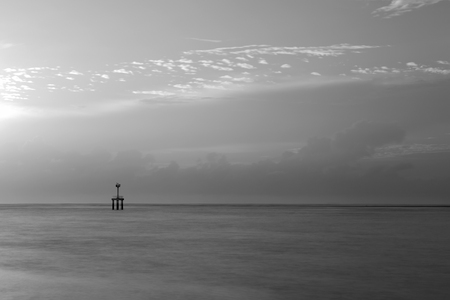 black and white lighthouse landscape in cloudy day with long exposureの写真素材
