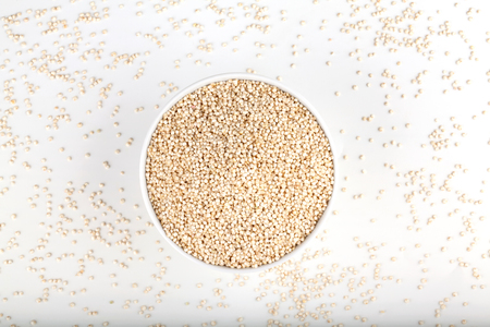 quinoa in white ceramic bowl on white backgroundの写真素材